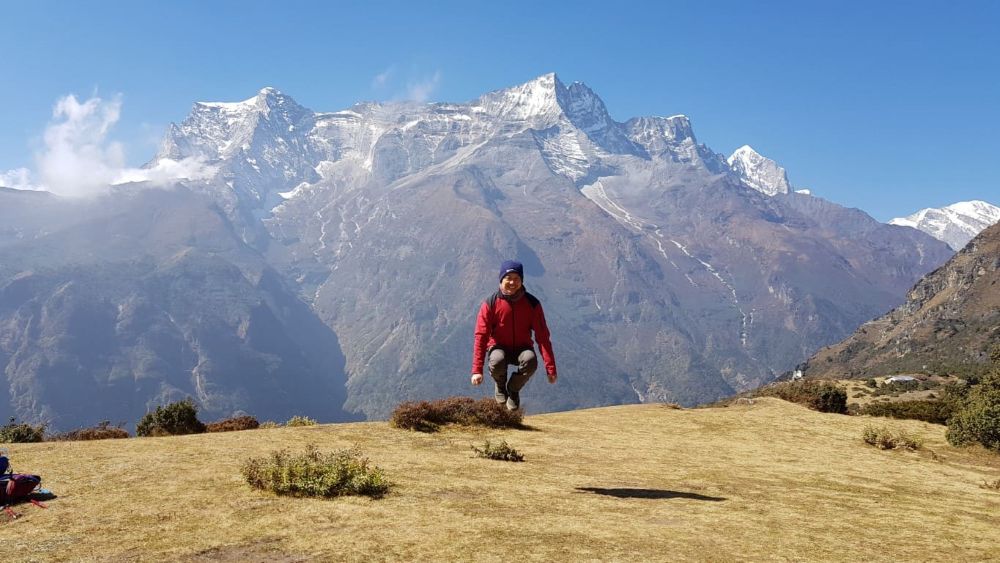 Trekker celebrating successful Everest view from Gokyo summit