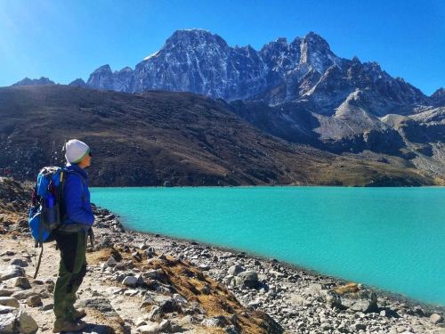 A trekker standing at Gokyo Ri lake and enjoying panoramic views
